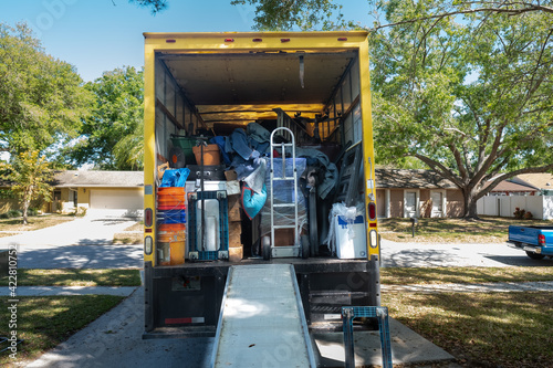 Belongings from a house being loaded into a moving van