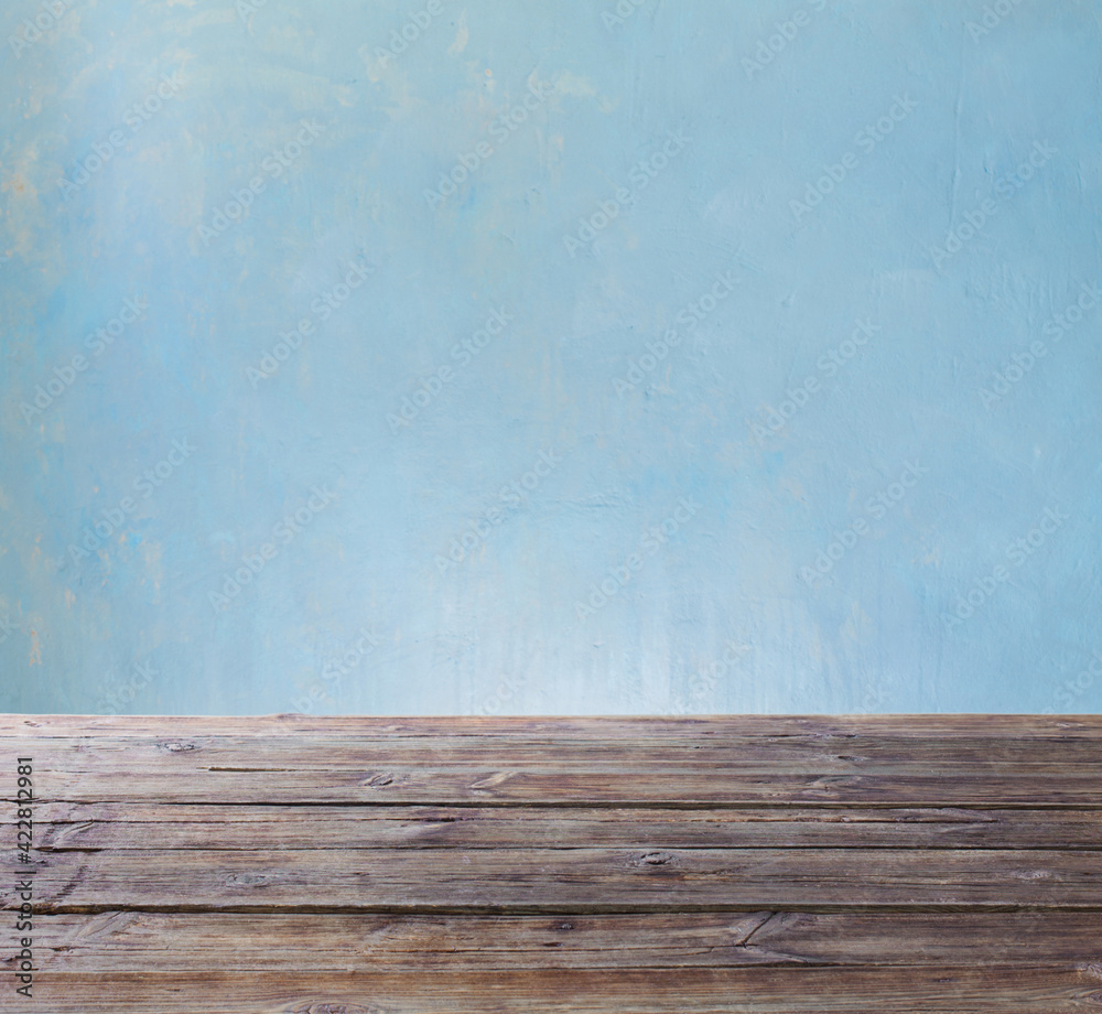 old wooden table on background blue wall old wooden table on background blue wall