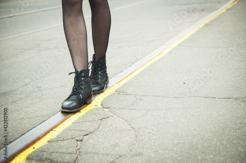 Girl walking on the tracks of the tram