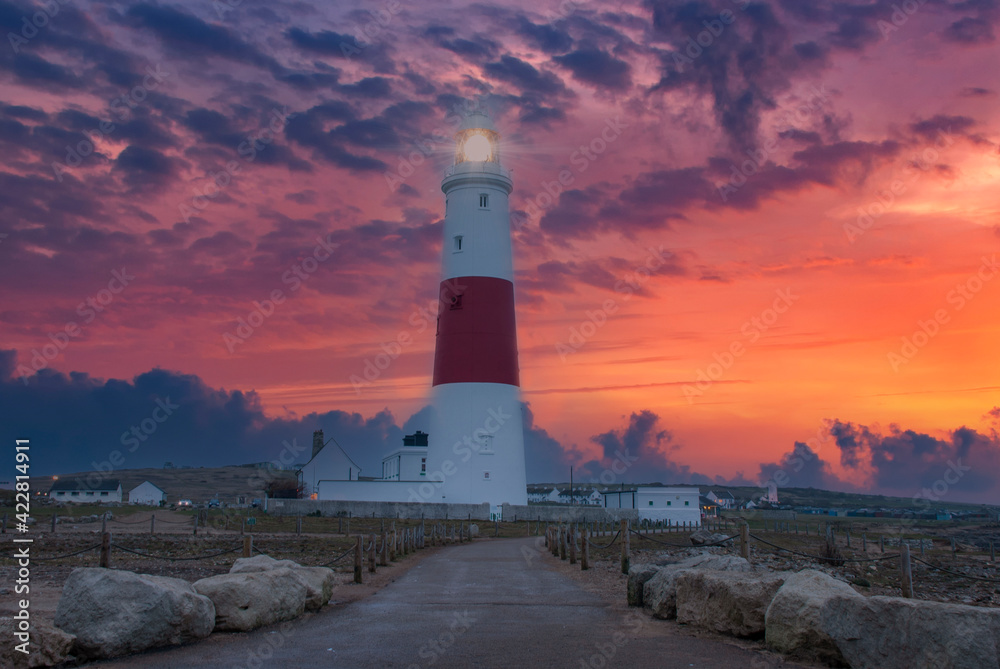 A dramatic sunset at the Portland Bill lighthouse on the south coast of England in Dorset