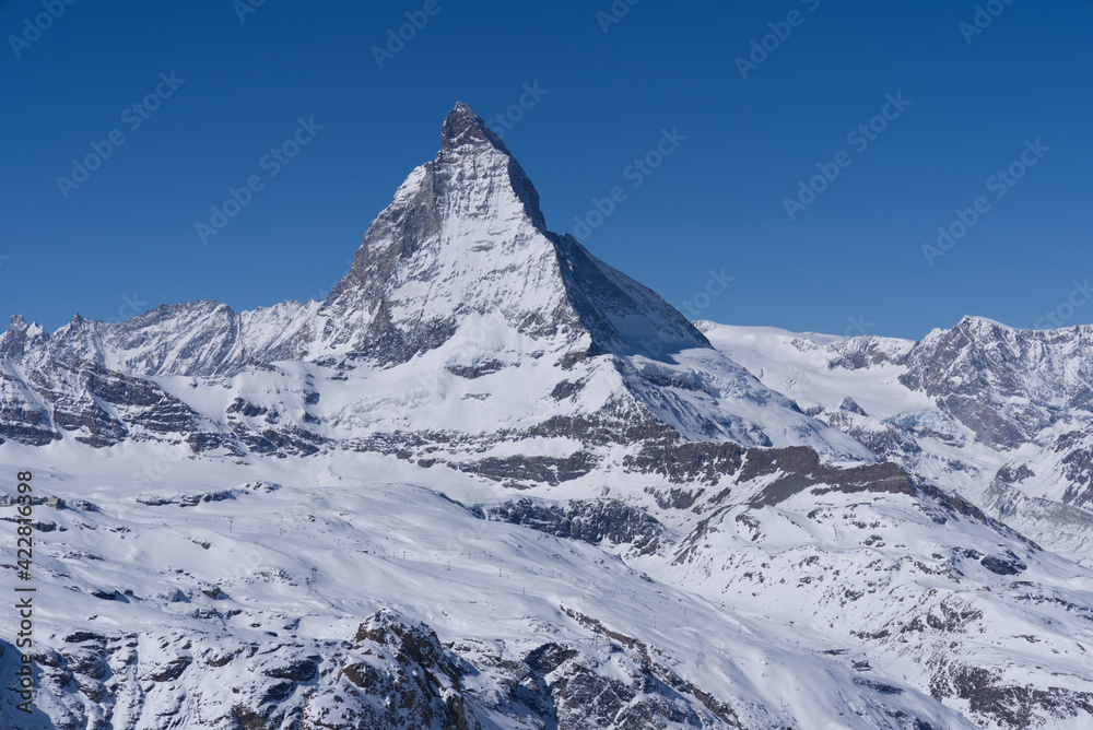 Beautiful winter mountain panorama with famous peak Matterhorn (4478m) seen from Gornergrat, Zermatt, Switzerland. Photo taken March 23rd, 2021.