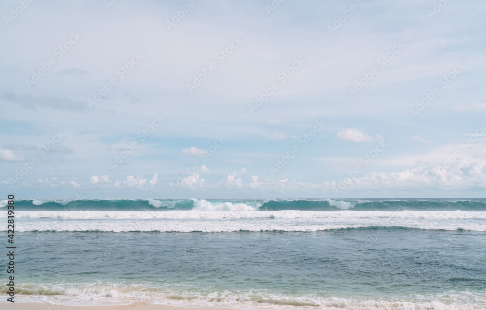 Foamy waves washing empty seashore