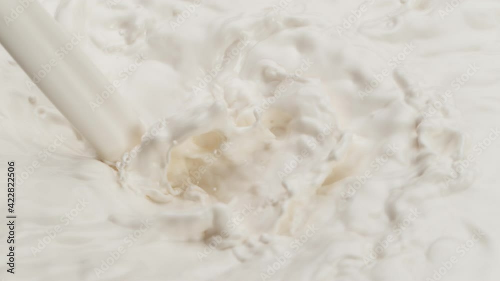 Super slow motion of mixing cream or milk with pouring splash. Filmed on high speed cinema camera, 1000 fps.