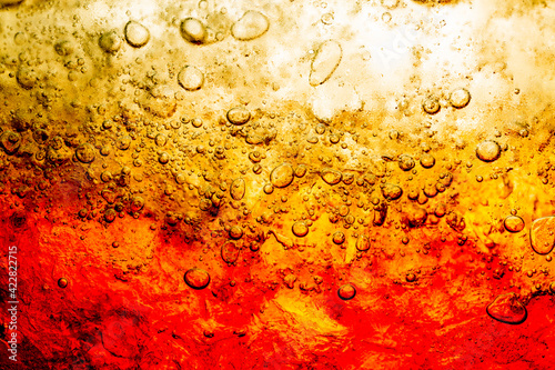 Soft drink glass with ice splash on dark background. Cola glass in celebration party concept.