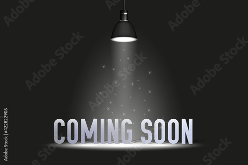 Coming soon text under spotlight. Vector illustration isolated on black