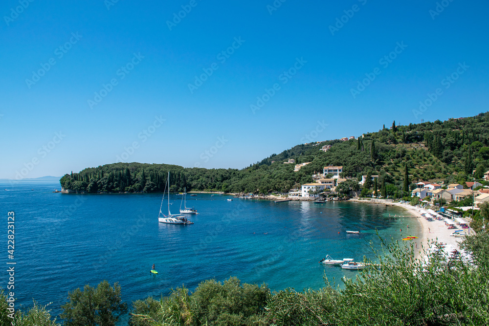 Summer panoramic seascape. View of the coast of Corfu with yachts and villas. The Ionian Archipelago. Greece