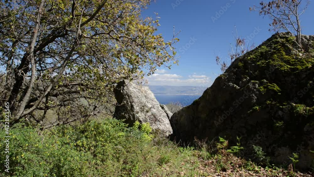 panoramic view of the Messina strait in a particular spring day with blue sky and limpid coast of Calabria with splashes of snow on the hills panoramic view of the Messina strait in a particular spring day with blue sky and limpid coast of Calabria with splashes of snow on the hills