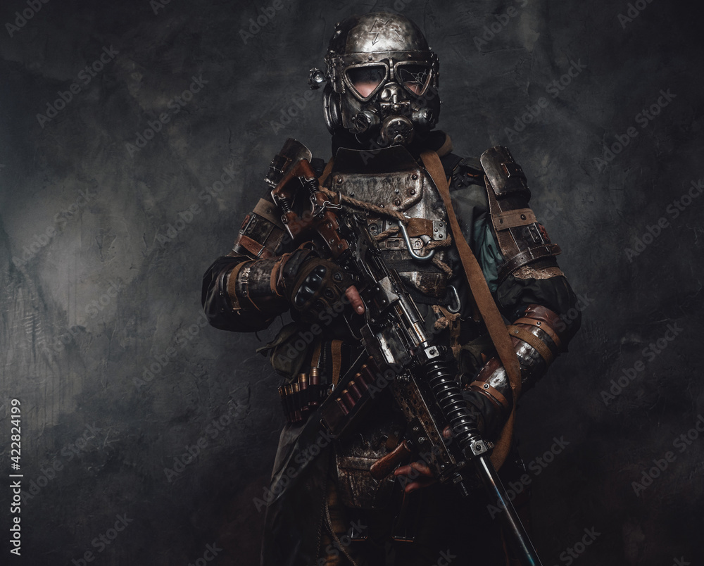 Apocalyptic armoured hunter with riffle in dark background