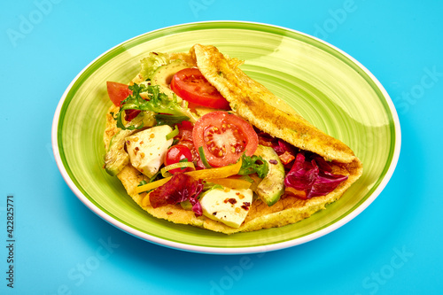 Omelette with avocado, tomatoes and mozzarella cheese. Healthy breakfast. High resolution image