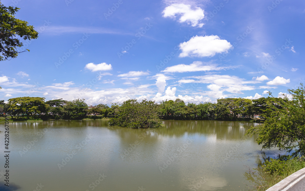 Panoramic of a lake, trees and blue sky. Lake Chilicote Tuluá Valle del Cauca Colombia.