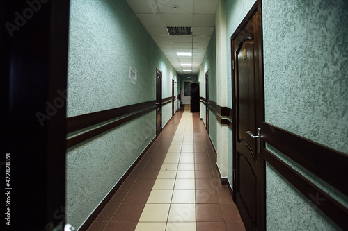 the corridor of the hotel with the doors to the rooms. minimalistic design of a long office corridor