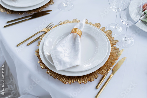 Beautiful served table, golden dishes, top view. Wedding event.