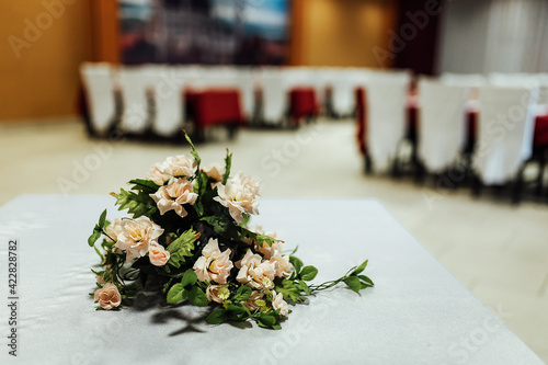 flowers on the table in the restaurant. decorated with a bouquet, a set table is waiting for guests. interior of an expensive restaurant