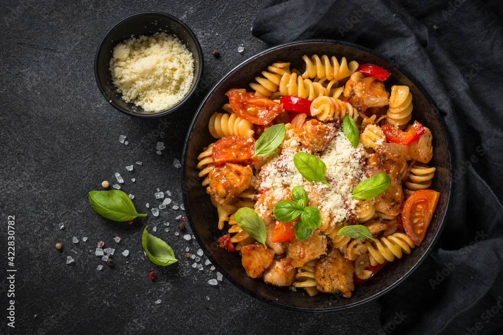 Pasta chicken with vegetables on black. Pasta chicken with vegetables on black.