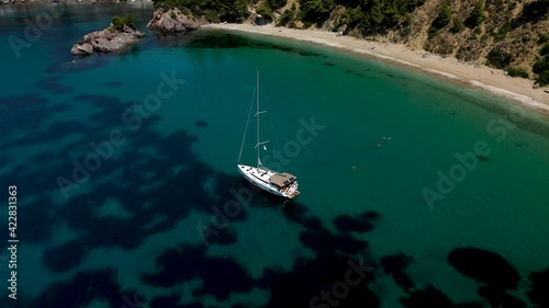 Drone aerial view of tourists enjoying a paradise luxury Yacht trip around Skopelos island, Greece, Aegean Sea, Europe.