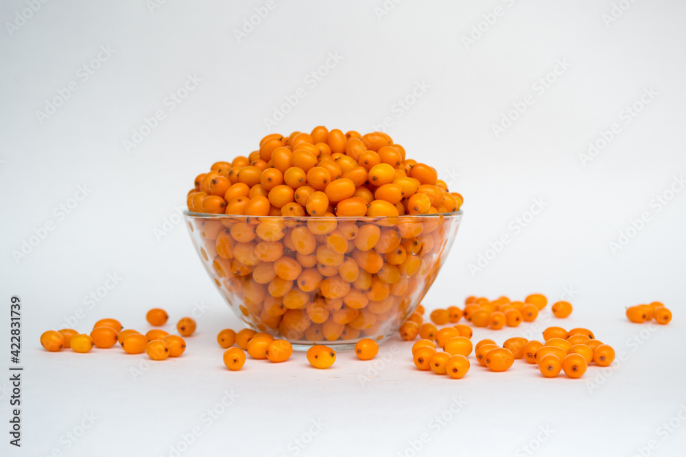 Sea buckthorn on a white background. Natural, organic sea buckthorn berries in a bowl Sea buckthorn on a white background. Natural, organic sea buckthorn berries in a bowl