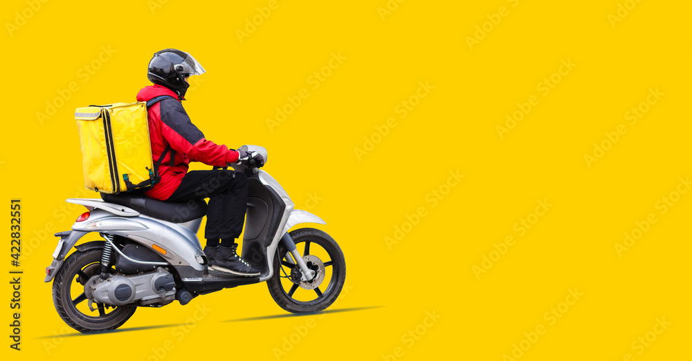 Portrait of delivery man in uniform holding parcel box isolated over yellow background Portrait of delivery man in uniform holding parcel box isolated over yellow background