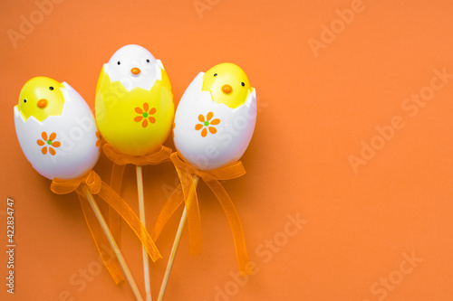 Colorful Easter eggs on pastel orange background.