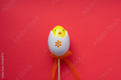 Colorful Easter egg chick on pink red background