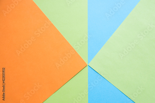 Color papers geometry flat composition background with green, orange and blue tones.New Minimal Flat design. Colorful new Paper modern background. Bright colors for fresh and modern graphics.