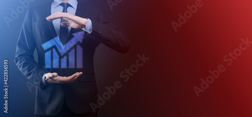Development and growth concept.Businessman hold graph growth and increase of chart positive indicators in his business,in hand.