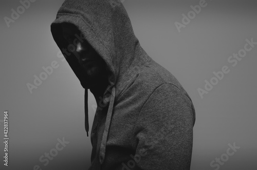 a man in a gray sports jacket with a hood