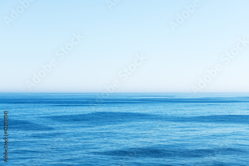 Ocean water and blue sky abstract background. Sea water texture closeup
