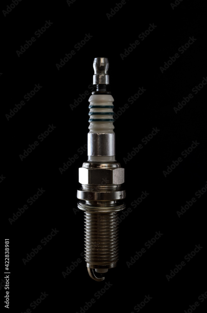 spark plugs for a car engine on a dark background spark plugs for a car engine on a dark background