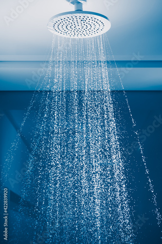 douche with water stream, blue background