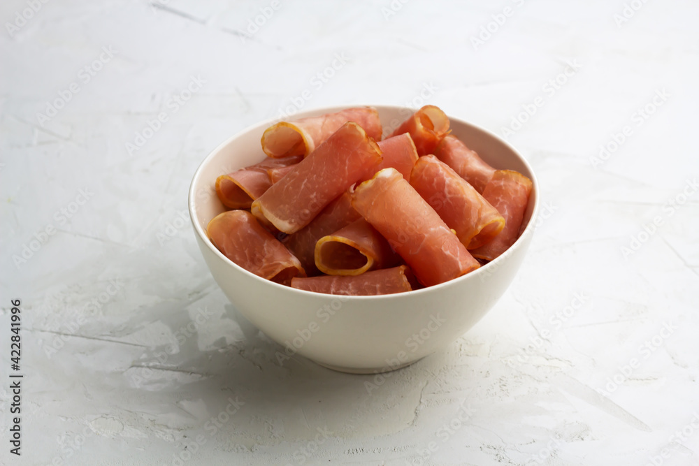 Trendy jerky meat in a white bowl. Selective focus Trendy jerky meat in a white bowl. Selective focus