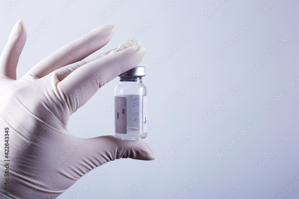 woman doctor holding flu vaccine in hands