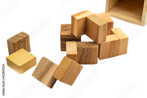 Wooden brain cube. Wooden puzzle made up of parts isolated on a white background. Business success concept. Layout for presentation.