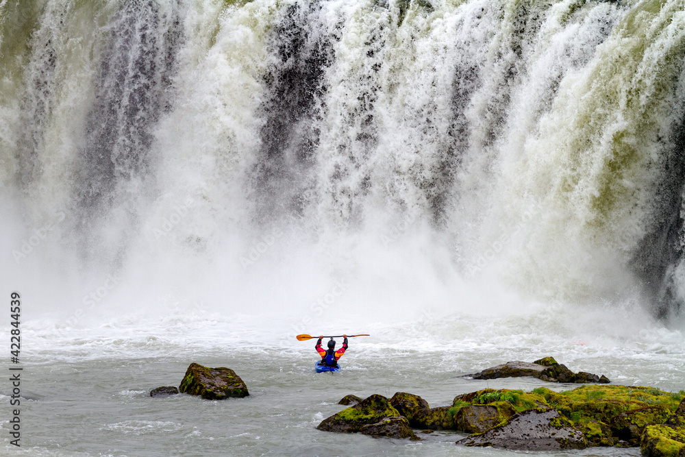 man sportive kayaking extreme adventure in waterfalls cold water falling success happiness and freedom