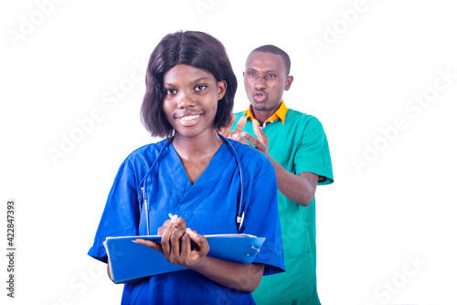 portrait of a young nurse with notepad, smiling.