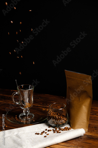 coffee beans fall into a glass cup. Coffee beans.
