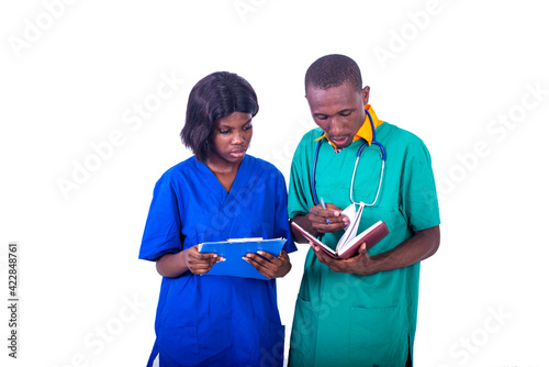 Doctor and nurse checking patient medical reports on clipboard at hospital. photo