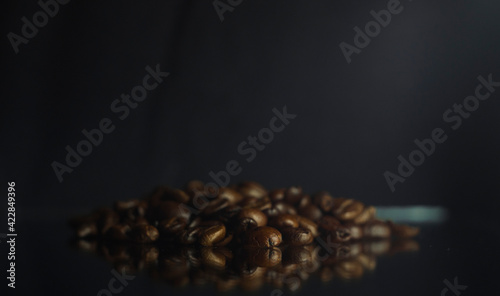 Brown Roasted Coffee Beans Closeup On Dark Background Whith Reflex