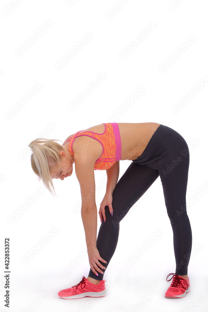 During intensive training, the girl unexpectedly caught a cramp in the calf During intensive training, the girl unexpectedly caught a cramp in the calf