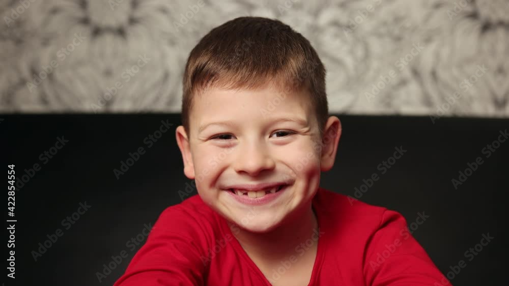 Portrait of boy looking into a camera, smiling. Social distancing and isolation Portrait of boy looking into a camera, smiling. Social distancing and isolation