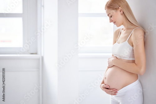 beautiful blonde pregnant woman stand having rest posing Free Download beautiful blonde pregnant woman stand having rest posing - GFXLoad