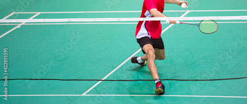 Professional badminton player beats the shuttlecock in the arena © Augustas Cetkauskas