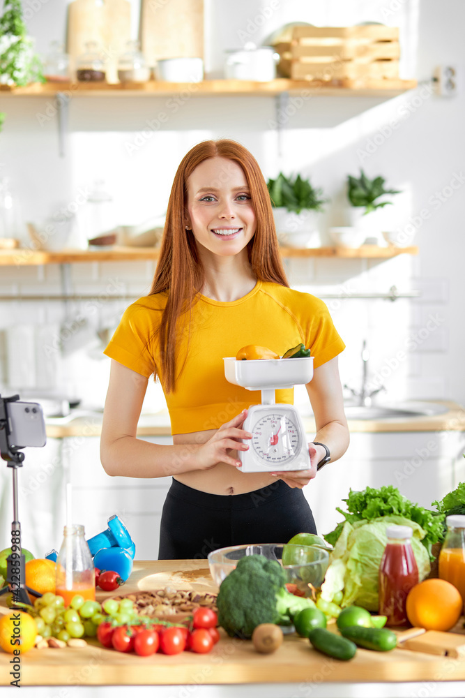 joyful sports woman with lots of healthy fresh food in kitchen. Concept of losing weight, sports and healthy eating joyful sports woman with lots of healthy fresh food in kitchen. Concept of losing weight, sports and healthy eating