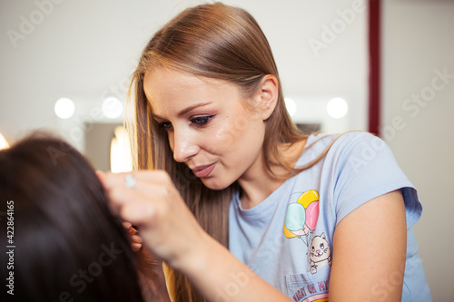 Artist doing professional make up of woman