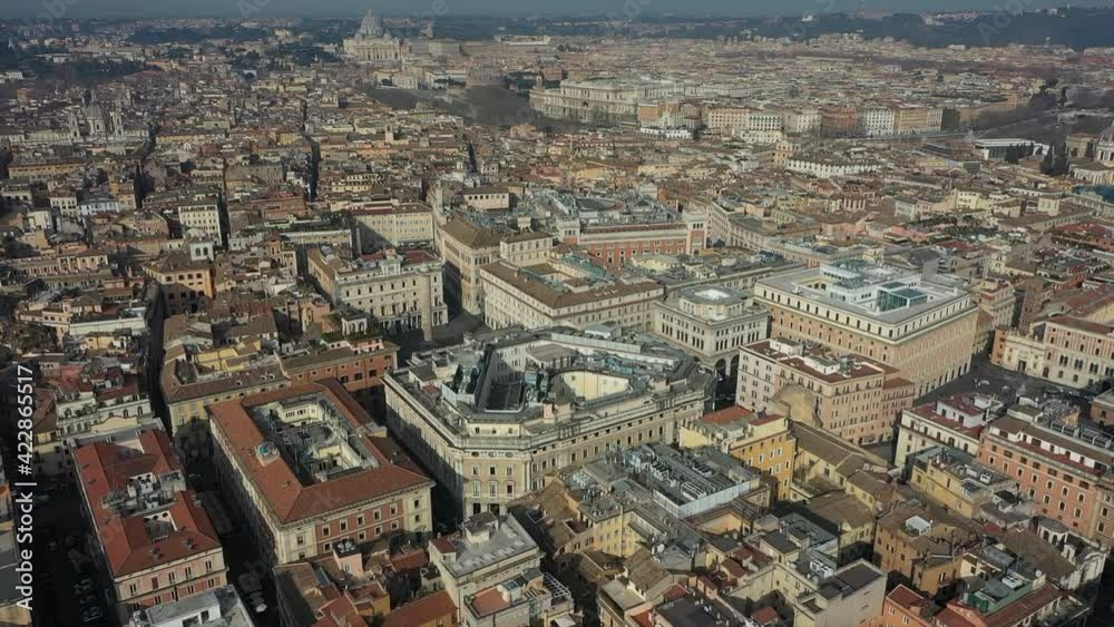 Aerial view of downtown Rome, Italy. City center with government buildings seen from drone flying in sky and Saint Peter's Basilica in Vatican City in background. Italian panoramic urban landscape Aerial view of downtown Rome, Italy. City center with government buildings seen from drone flying in sky and Saint Peter's Basilica in Vatican City in background. Italian panoramic urban landscape