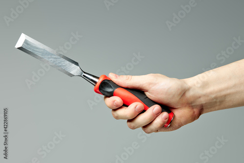 Foto chisel of wood for carpentry isolated on gray background