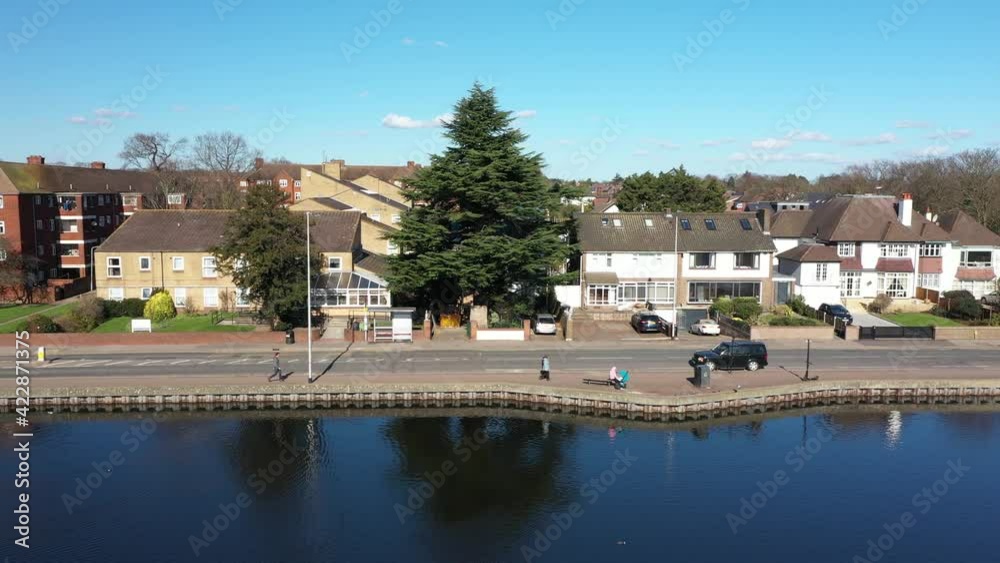 FLYING SIDEWAY OVER A POND WITH A TOWN IN THE BACKGROUND. FLYING SIDEWAY OVER A POND WITH A TOWN IN THE BACKGROUND.