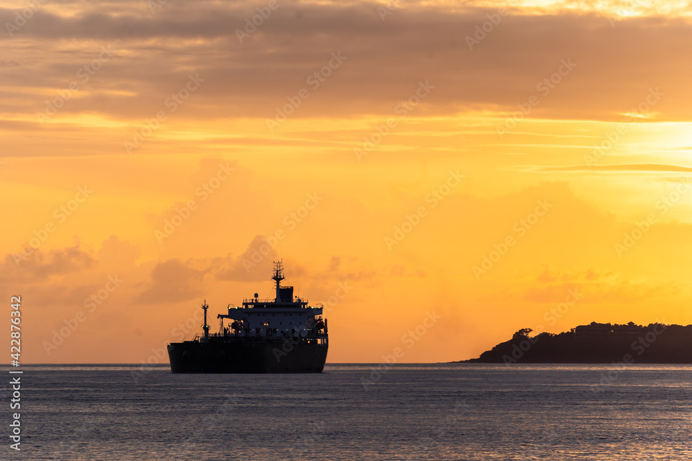 Sunset over an oil tanker off the ocast of Bali near Padang Bai in Indonesia