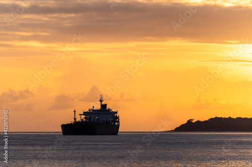 Sunset over an oil tanker off the ocast of Bali near Padang Bai in Indonesia © jakartatravel