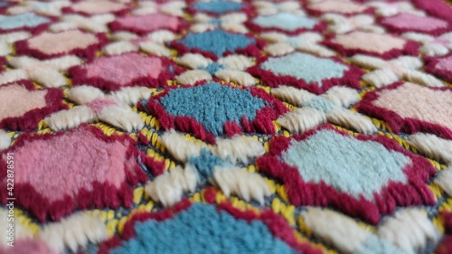 close up of colorful fabric, arabic arabesque islamic ornamental colorful detail. Fabric prayer carpet muslim close up © RMTH