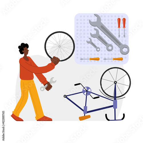 Bicycle repair. A black man repairs a bicycle. The mechanic repairs the bicycle, the mechanic inflates the wheels. Web graphics, banners, advertisements, business templates. 